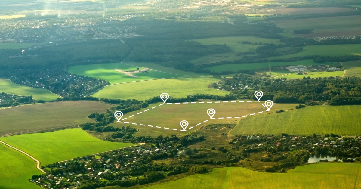 An aerial view shows farmland outlined with location markers highlighting property boundaries across a rural landscape.