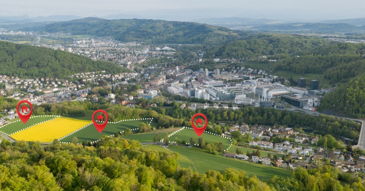 An aerial view shows several marked parcels of open land near residential neighborhoods and a developed urban area.